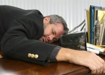 vyčerpaný muž na pracovním stole